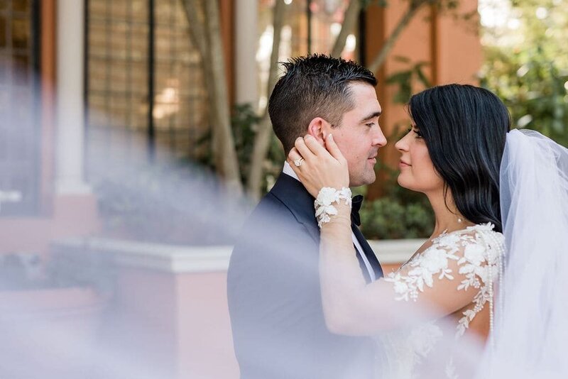 Bride has her hands on the grooms face as they look into each other's eyes