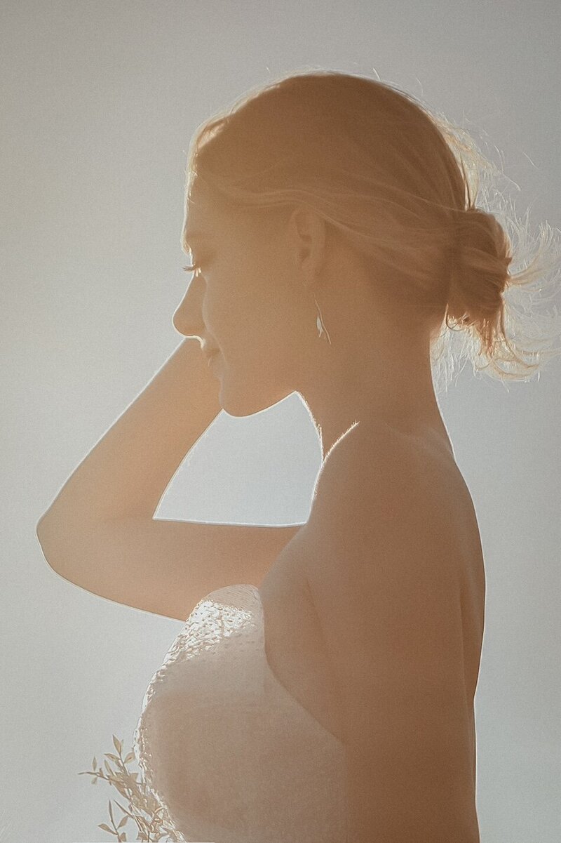 A golden light outdoor photoshoot of a woman wearing a couture dress.