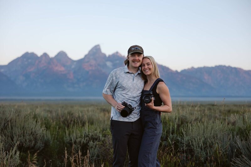 Lauren and Matt of Intimate Adventures Media standing in front of the Sawtooth Mountains in Stanley, Idaho after a wedding shoot