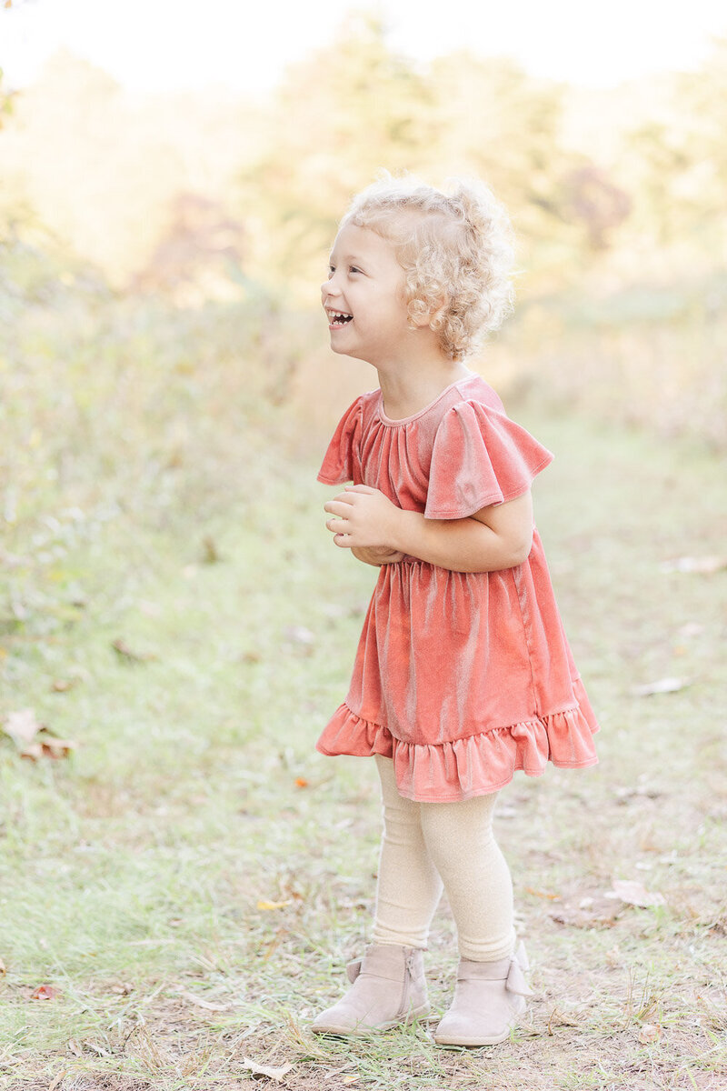 girl laughing during fall minis taken by a Gainesville, VA photographer