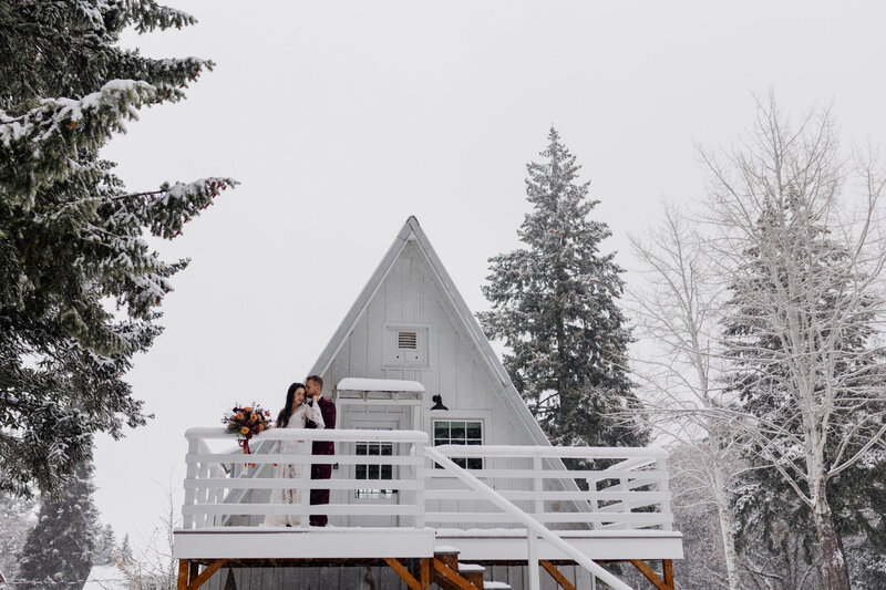 A-frame cabin covered in snow, evoking cozy winter elopement vibes.
