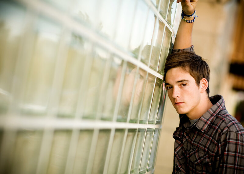 Senior boy leaning on a wall in Downtown Boise.