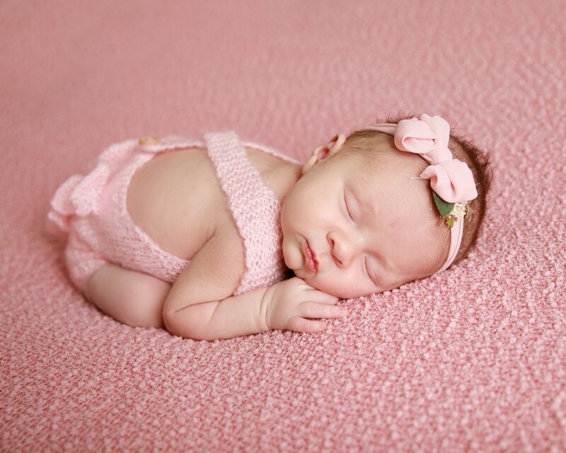Newborn Girl in pink knit romper