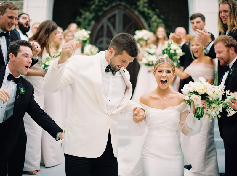 Bride and groom cheer as they leave their wedding ceremony as a married couple