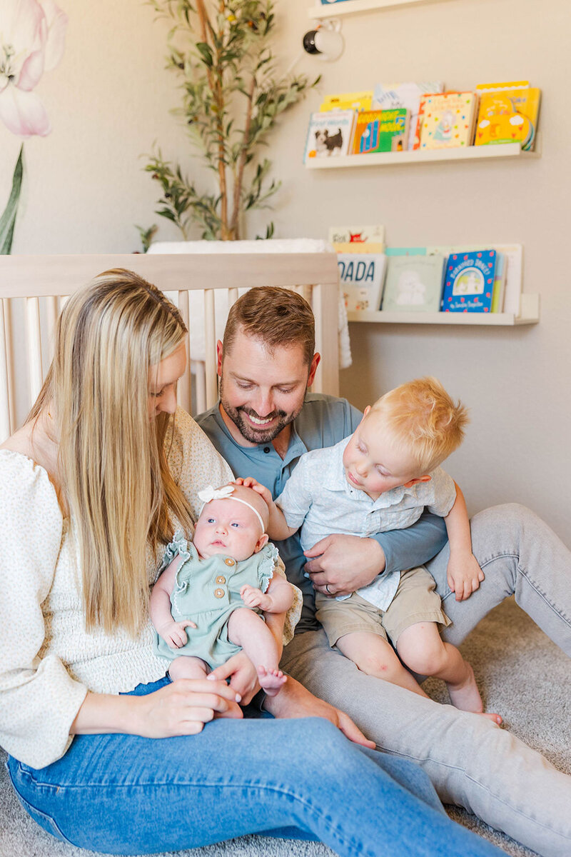 Adorable family capturing precious moments during their lifestyle newborn session in Laramie, Wyoming, showcasing love and connection in the comfort of their home.