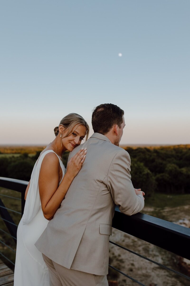 bride leans against groom after wedding in texas