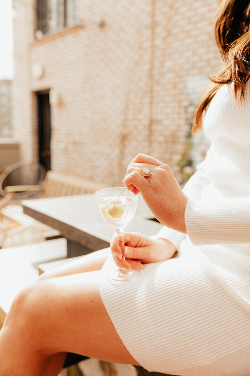 Bride showing off her engagement ring holding a martini at the Ramble Hotel 