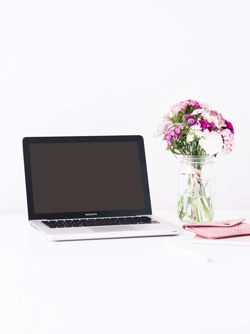 Computer and flowers to show luxury vacation concierge service GG Mack
