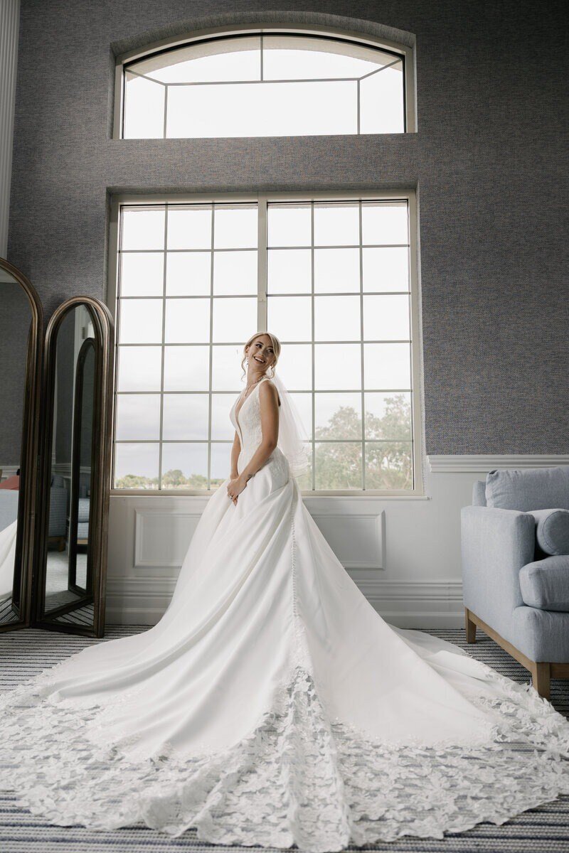 Gracey in her wedding dress reflection at The Club at The Strand, captured by Priscila Del Cristo, West Palm Beach wedding photographer. 
