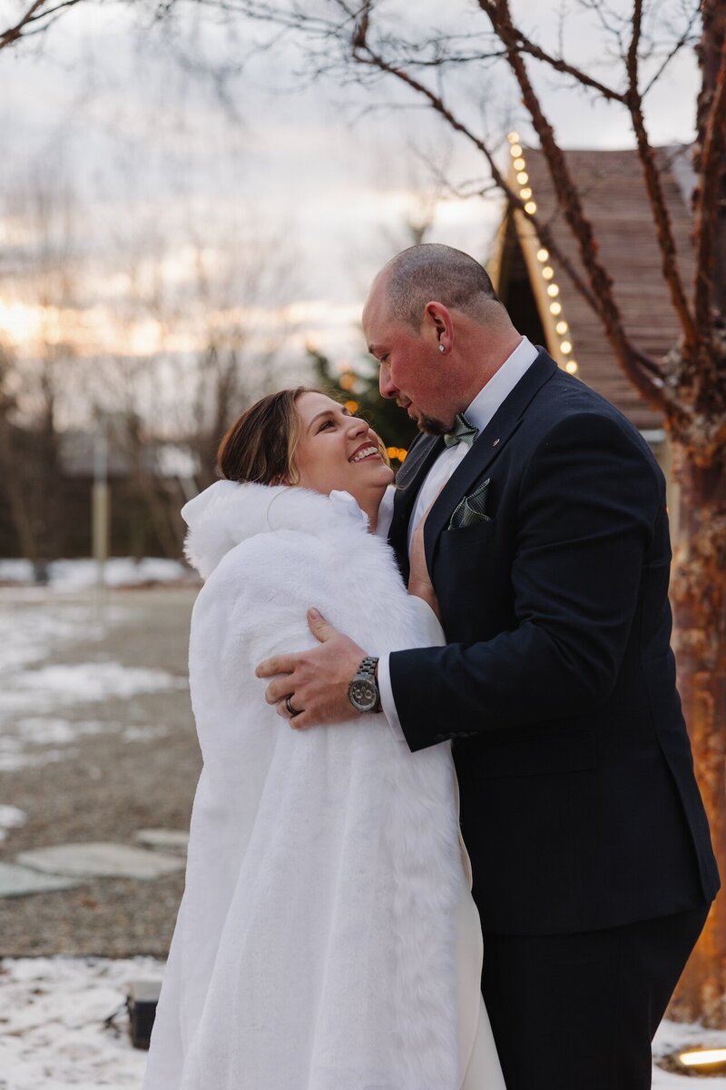 bride and groom embrace on wedding day in pennsylvania