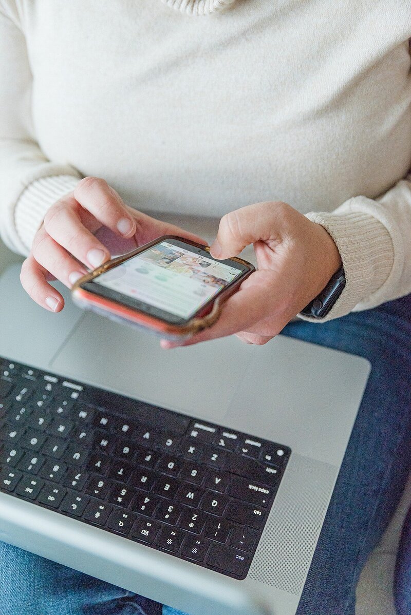 Woman scrolling through phone looking for photos