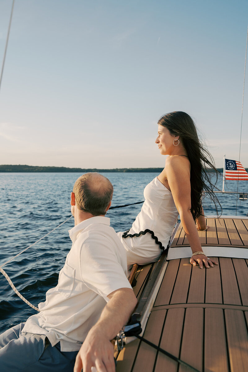 A woman and a man sitting on the top of a boat looking out in Nashville, Tennessee. Photo by Jaimee Raneigh Photography nashville based wedding photographer. 