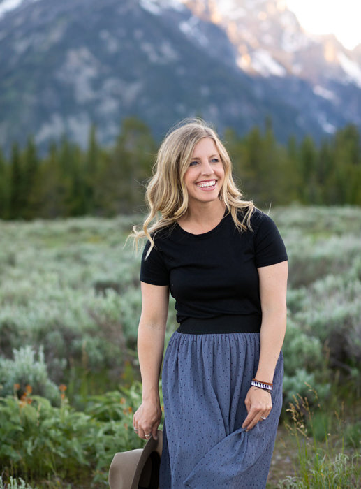 Washington elopement photographer Amy Galbraith walks through a sage field in Grand Teton National Park