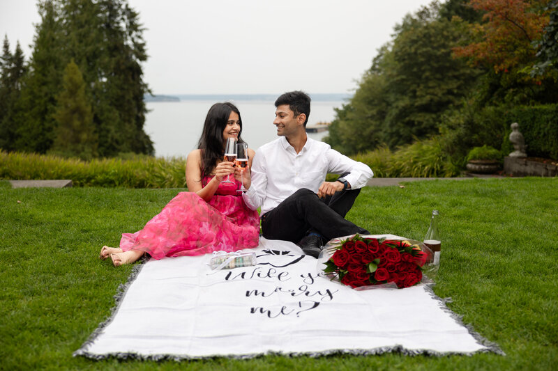 Champaign wedding proposal celebration photo with bride and groom fiance on beach front at Bainbridge Isalnd near Gig Harbor and Tacoma engagement