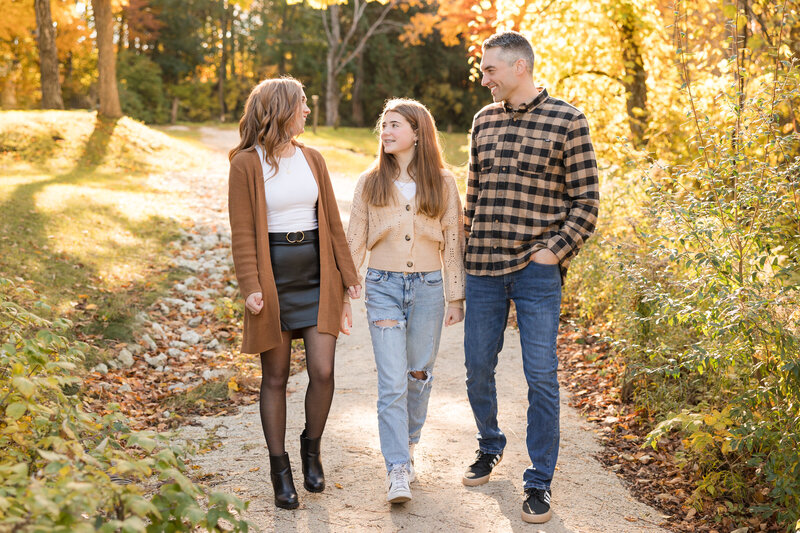 Family walking toward the camera and smiling at each other