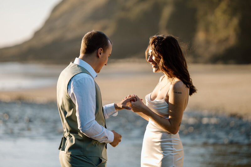 Bride and groom exchanging rings on the Oregon Coast.