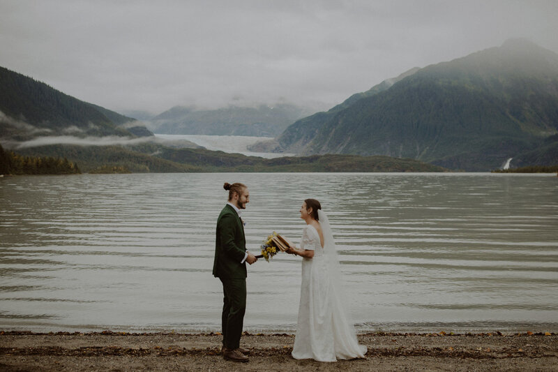 Couple reads their vows in front of glacial lake in Juneau, Alaska