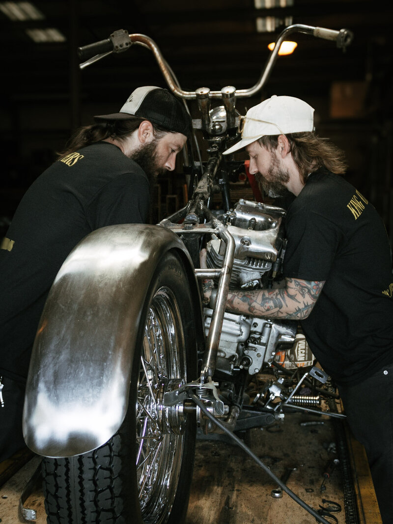 King City Choppers techs pulling a shovelhead engine out of the frame.