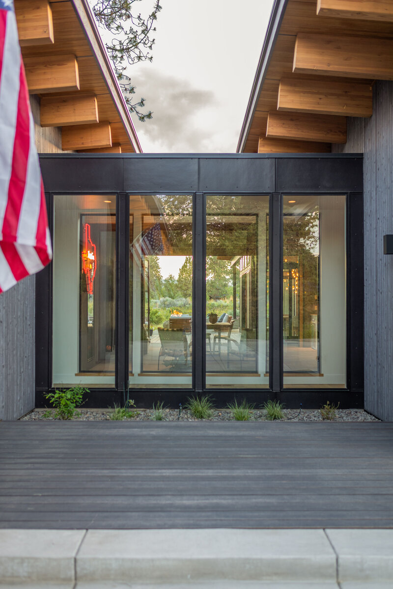 modern-mountain-house-glass-hallway-black-cladding