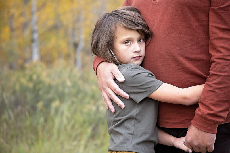 Child hugging their dad during a family session