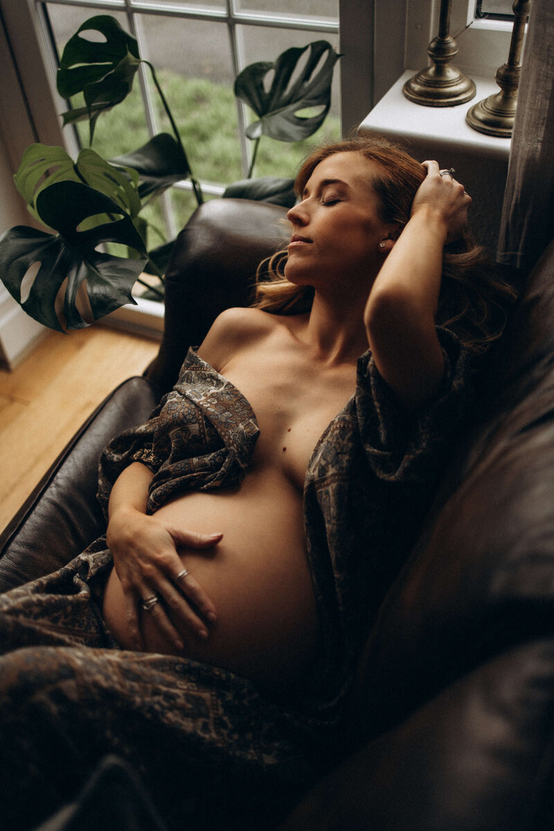 beautiful pregnant woman laying on a lounge at home