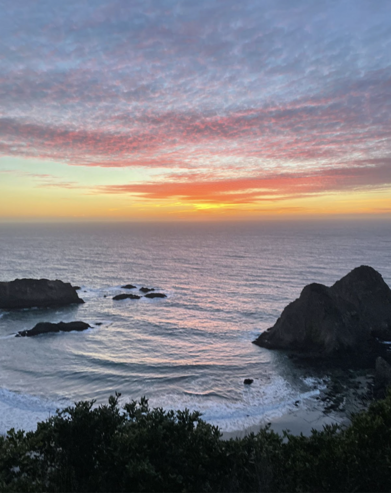 ocean at sunset with large rock formations in the water