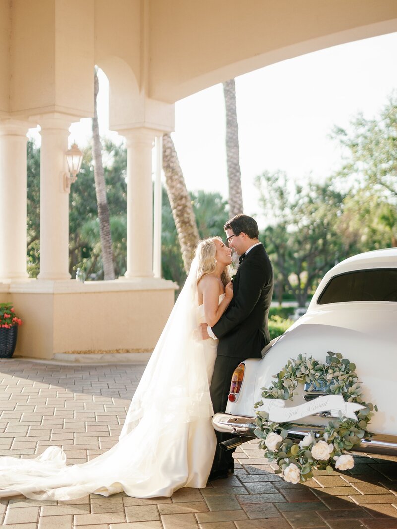 Bride and groom with vintage car