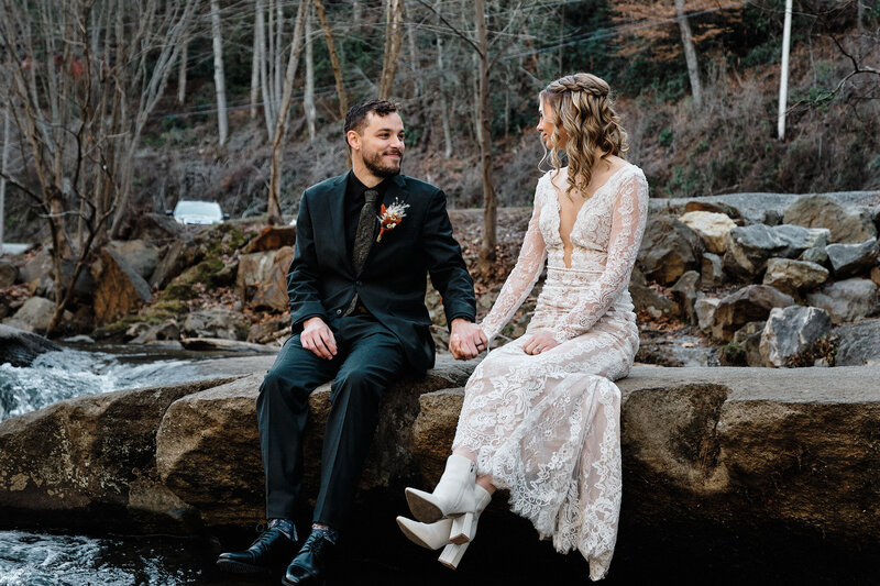 Wedding couple sitting and looking at each other.