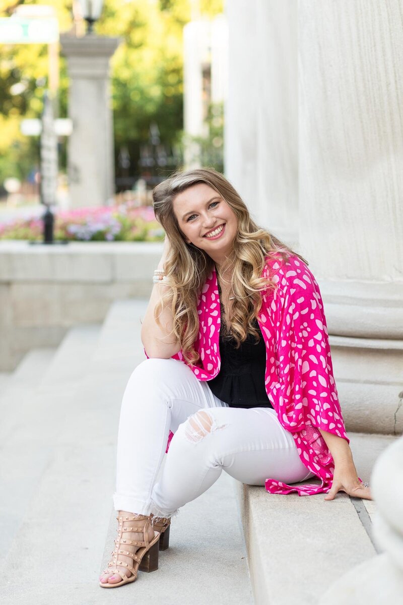 professional photo of Jade Buford in a pink shawl and white jeans