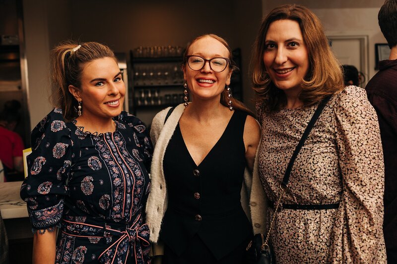 Friends toasting and celebrating during Dart Collective Chicago launch at Lou Lou by Lola Cafe