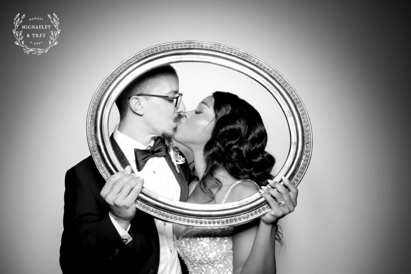 bride and groom posing for vintage photo booth in Houston