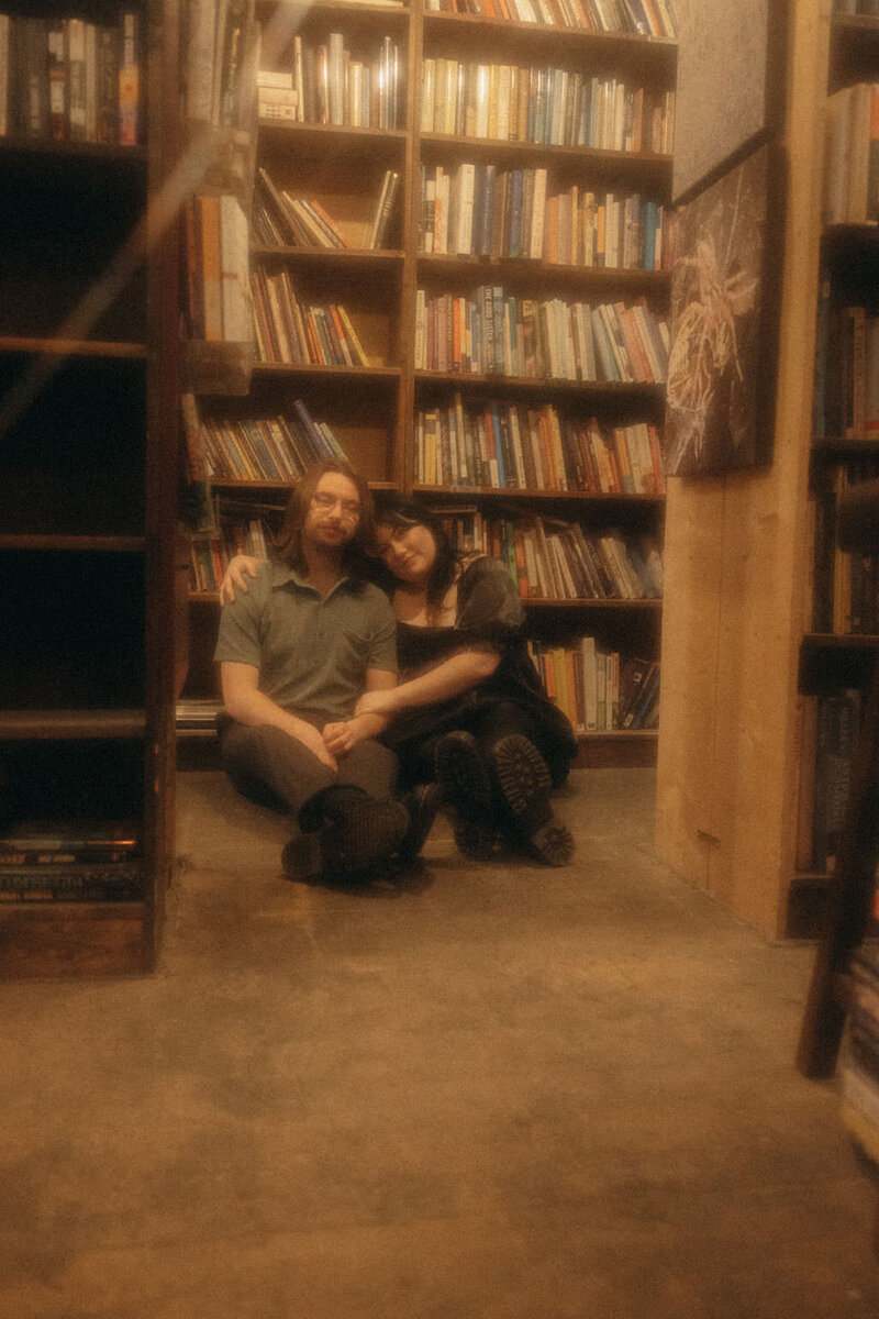 A couple sitting together in a bookstore.