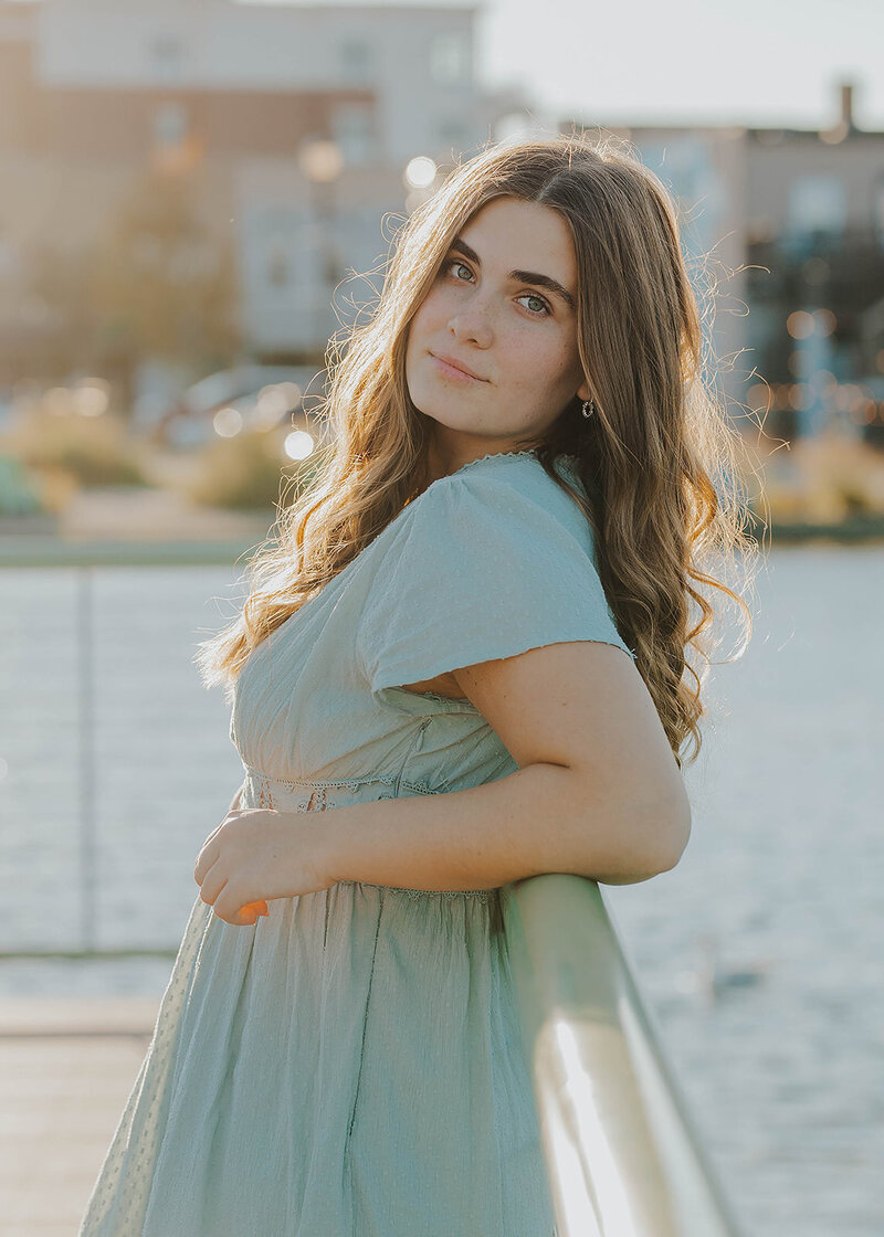 woman leaning on fence posing