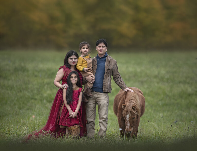 "A family portrait session in the autumn season, surrounded by fall foliage and warm, golden light in Ottawa."