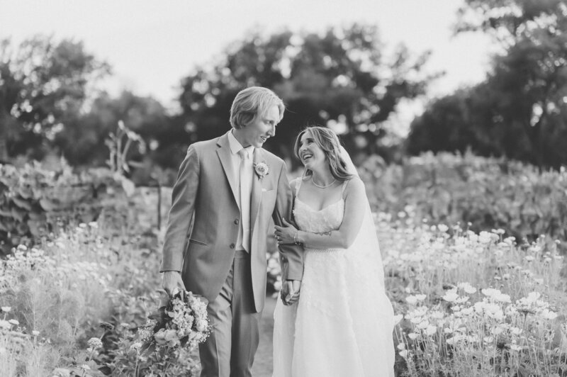 Timeless black and white photo of bride and groom walking at Old Town Farm.