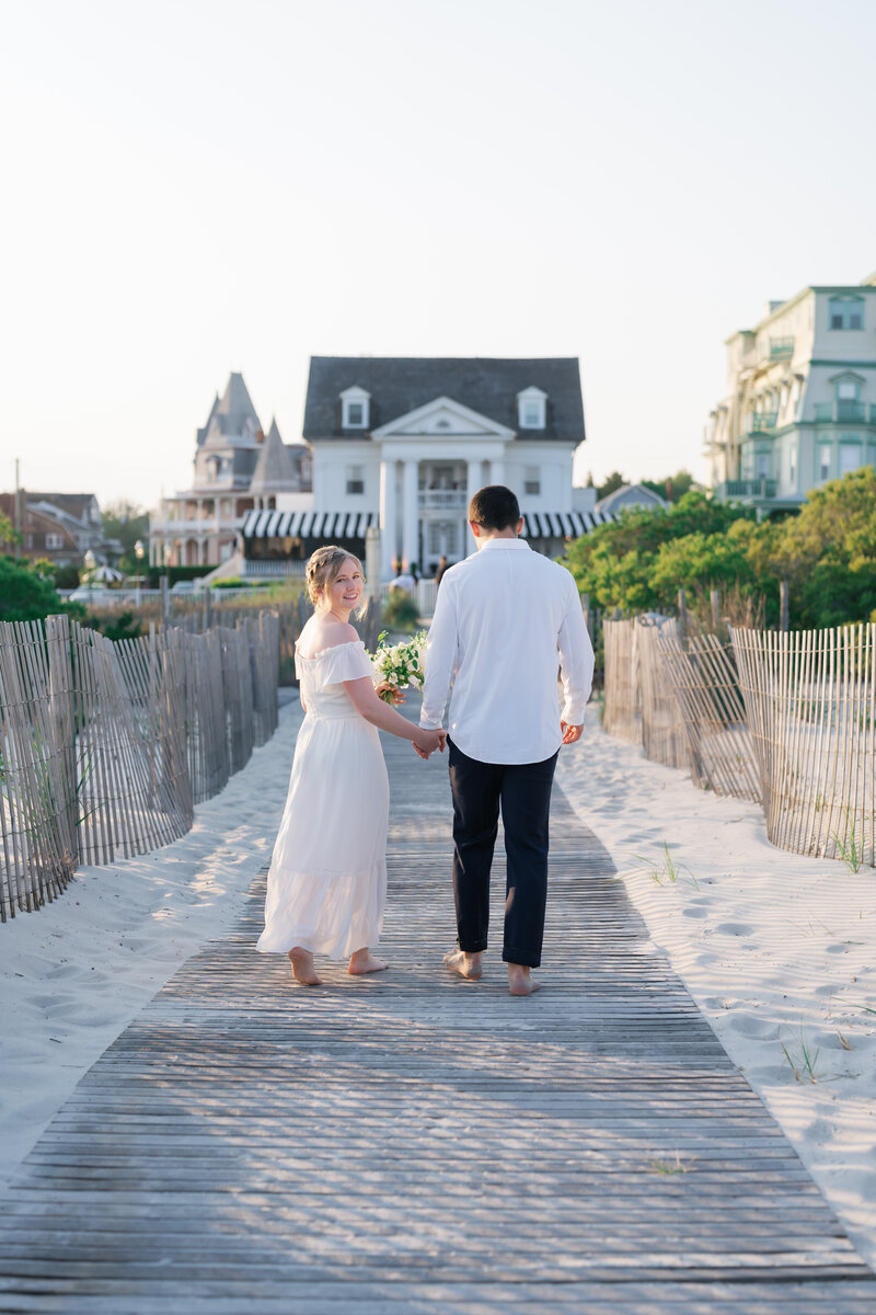 Bride and groom walking off the beach after wedding ceremony in Cape May, New Jersey