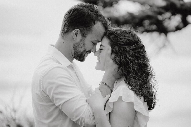 an engaged couple touching foreheads