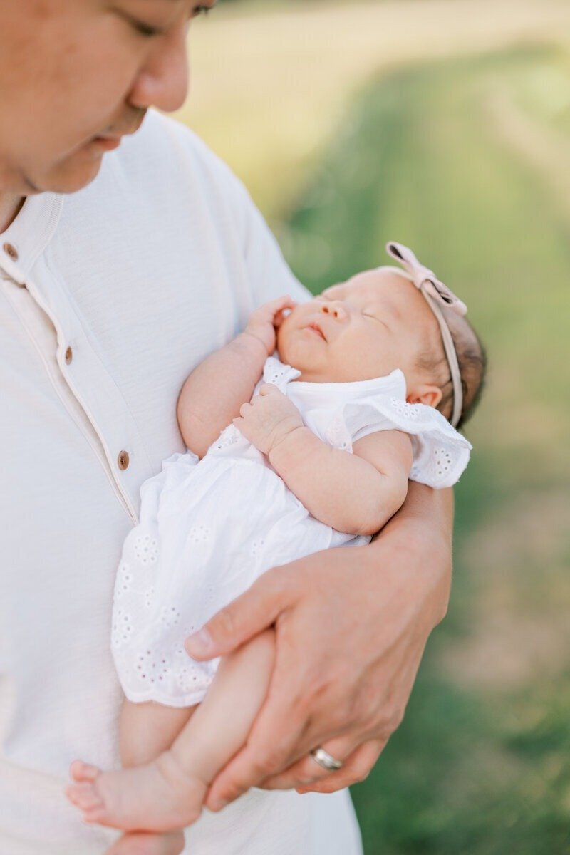 A tender moment between a father and his baby, captured by Emily Barbara, a family photographer in Milwaukee.
