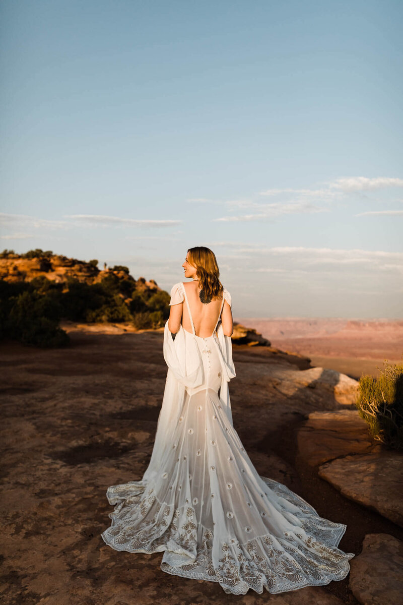 the eloping couple runs down the hall, the brides fringe and lace dress trailing behind her.