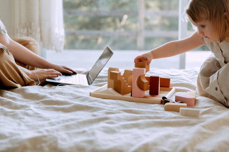 A home office scene with a computer and tea, illustrating the balance of working from home as a virtual assistant. Creative Dynamics provides flexible virtual assistant services for moms across the USA and Canada, supporting business tasks while accommodating family life. Photo courtesy of Unsplash.
