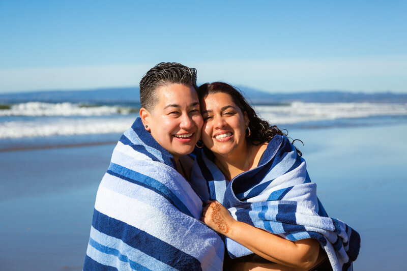 couple wrapped in a towel smiling together