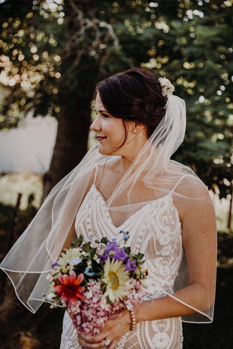 bride holding a colorful bouquet of flowers