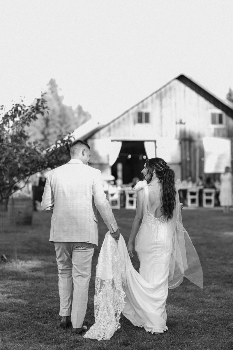 bride and groom walking toward the reception at twin creeks farm wedding in idaho