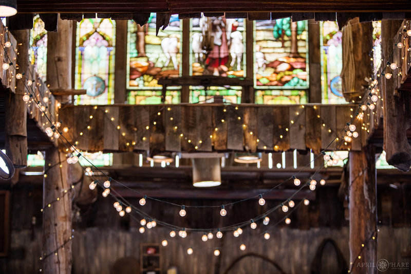 String lights and stained glass windows inside Barn at Evergreen Memorial Park