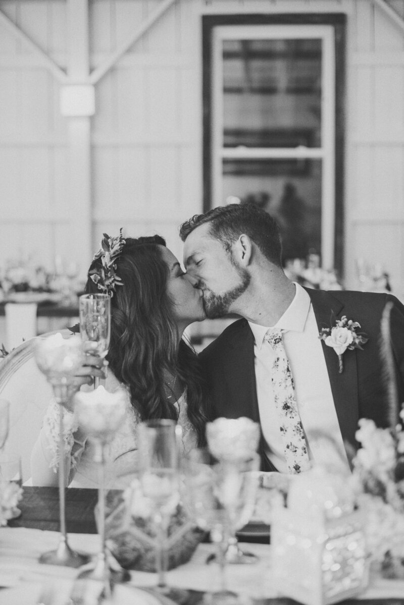 A groom and a Filipina bride kissing and raissing a glass of champagne