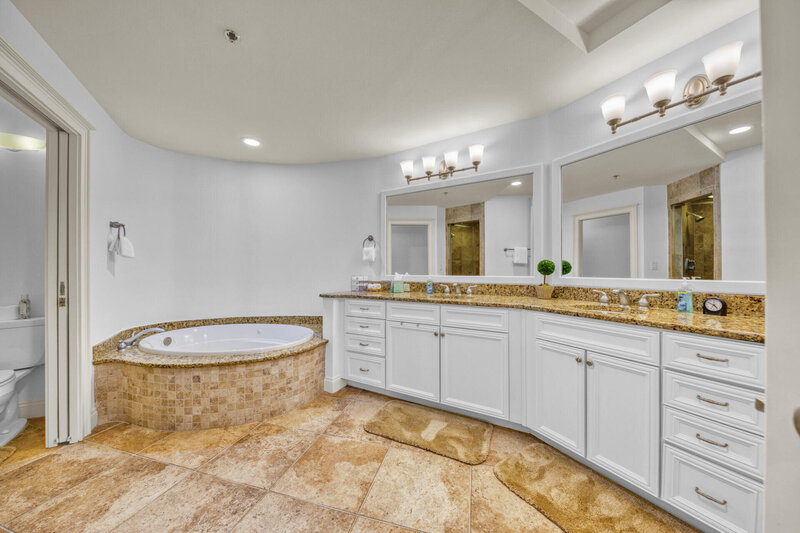 master bathroom with dual vanity and whirlpool tub