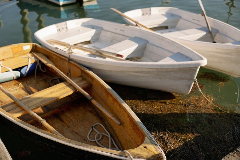 Colorful fishing boats docked in a busy Maine harbor on a sunny day