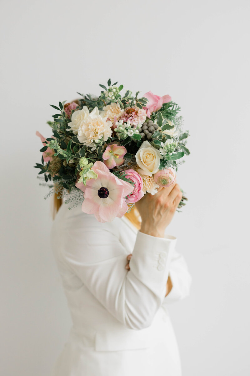 Newport Photographer Serving CT, RI, and beyond | The Corteses | Branding photo with a woman holding a bouquet