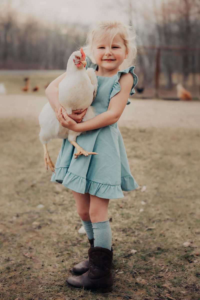 little girl with chicken luci levon photography