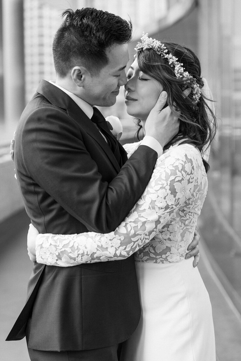 bride and groom embracing, nose to nose